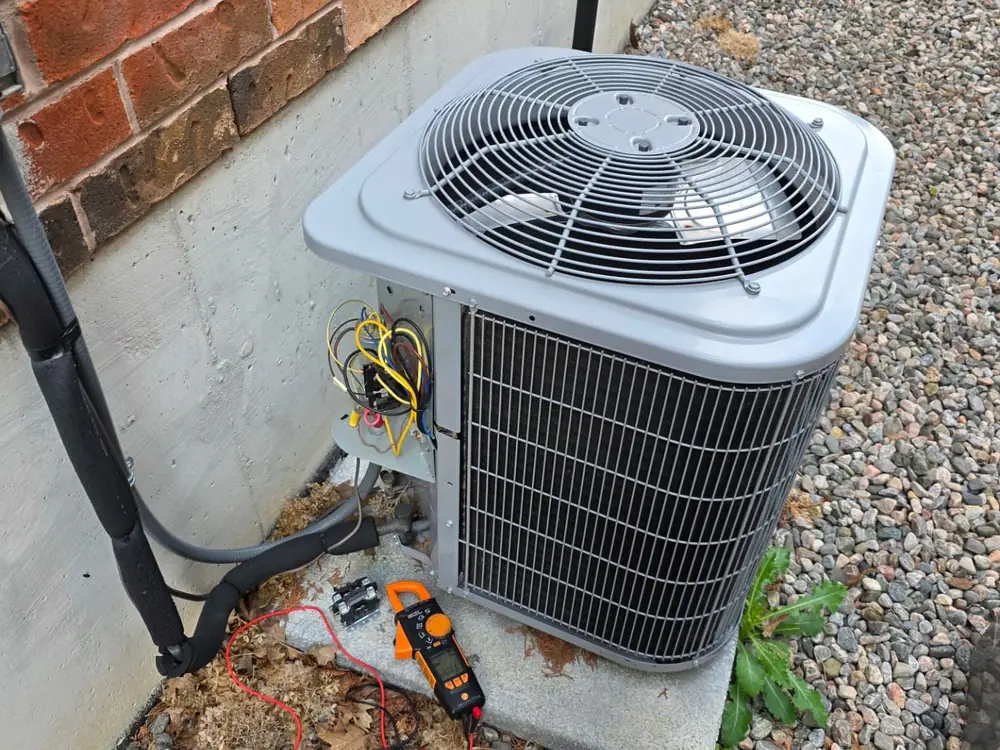 New high-efficiency air conditioner condenser installed on a level gravel base in Innisfil
