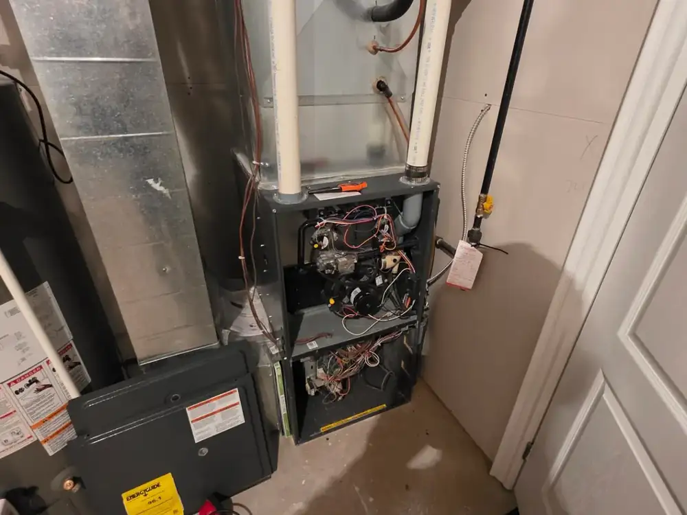 High-efficiency gas furnace opened for service in an Innisfil basement mechanical room