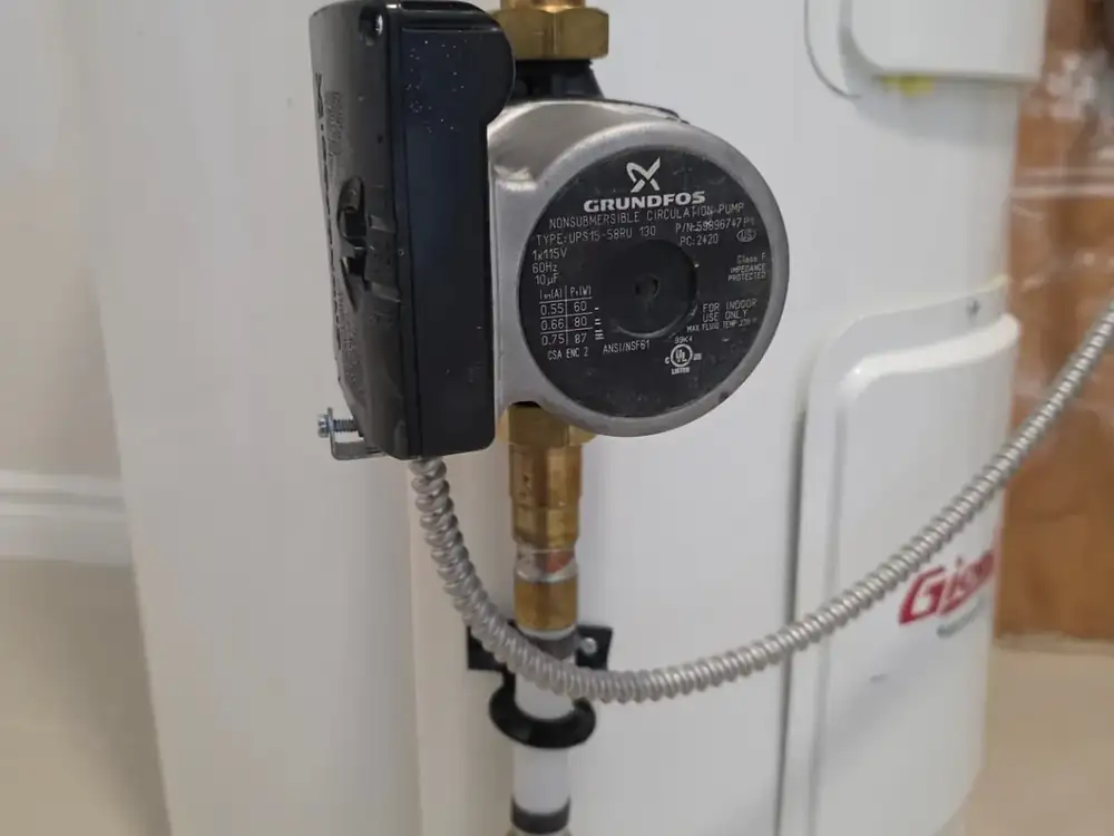 Recirculation pump installed on a hot water tank during a water heater service call